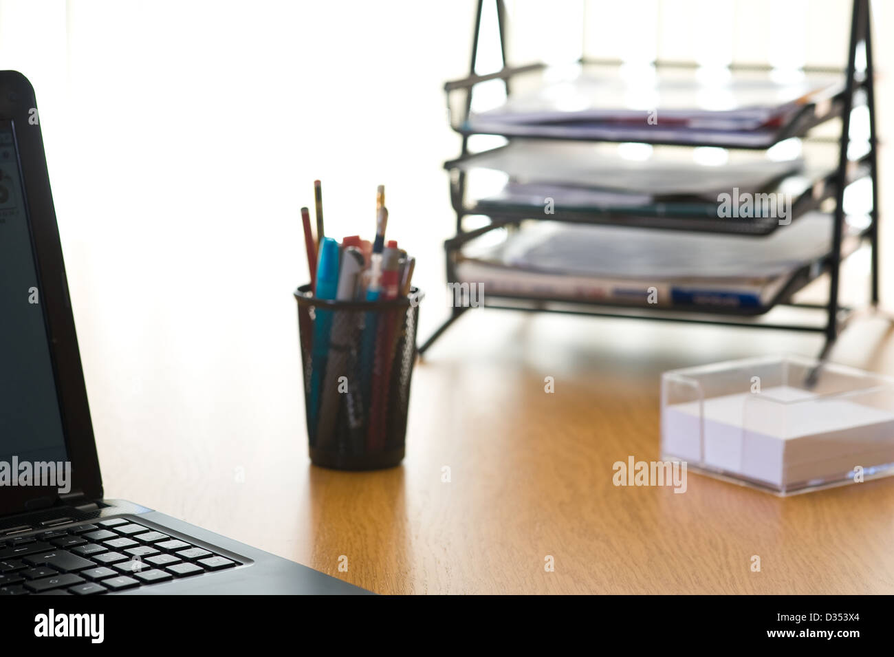 Modern office desk top, with in and out trays.. Stock Photo