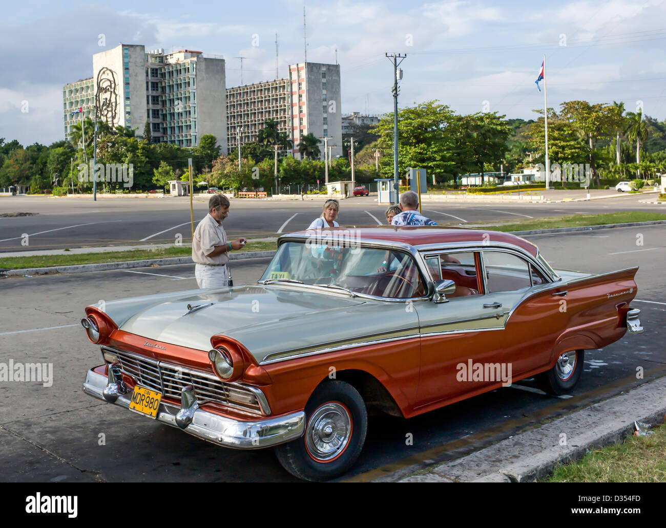 American 1950's Fairlane car in immaculate condition in Revolution Square, Vedadom, Havana, Cuba with tourist holiday makers. Stock Photo