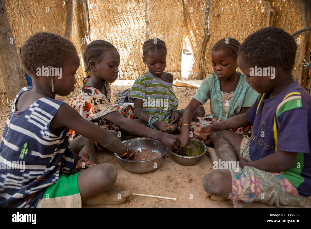 Barsalogho, Burkina Faso, May 2012: Children eat sauce made from baobab