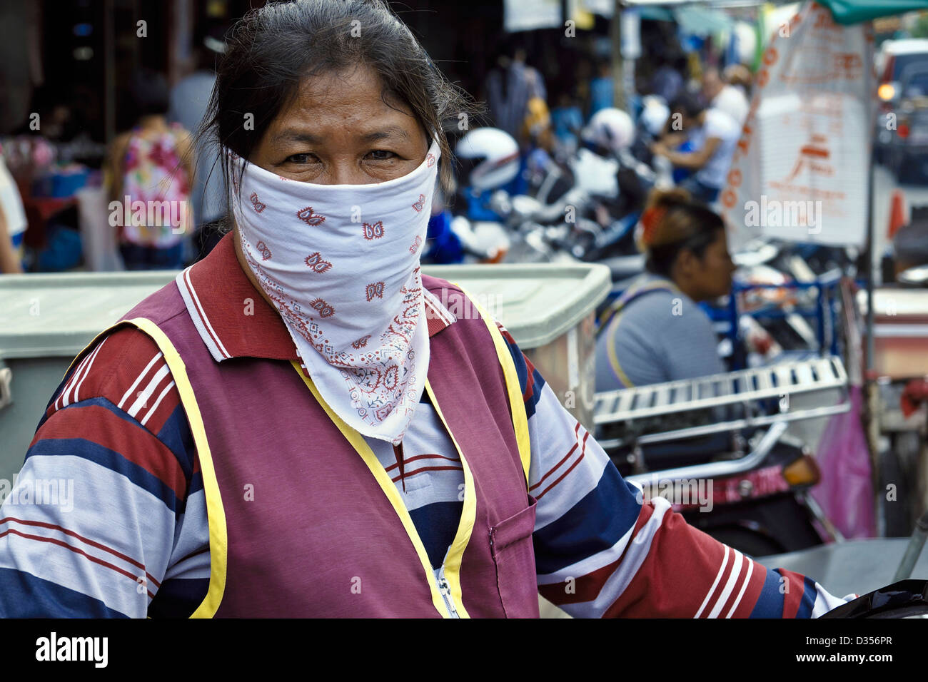 Thai female wearing a smog mask for protection against the Bangkok pollution. Thailand S. E. Asia Stock Photo