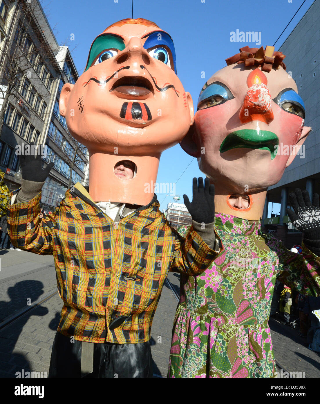 Socalled Schwellkoepp, giant paper mache heads, attend the carnival