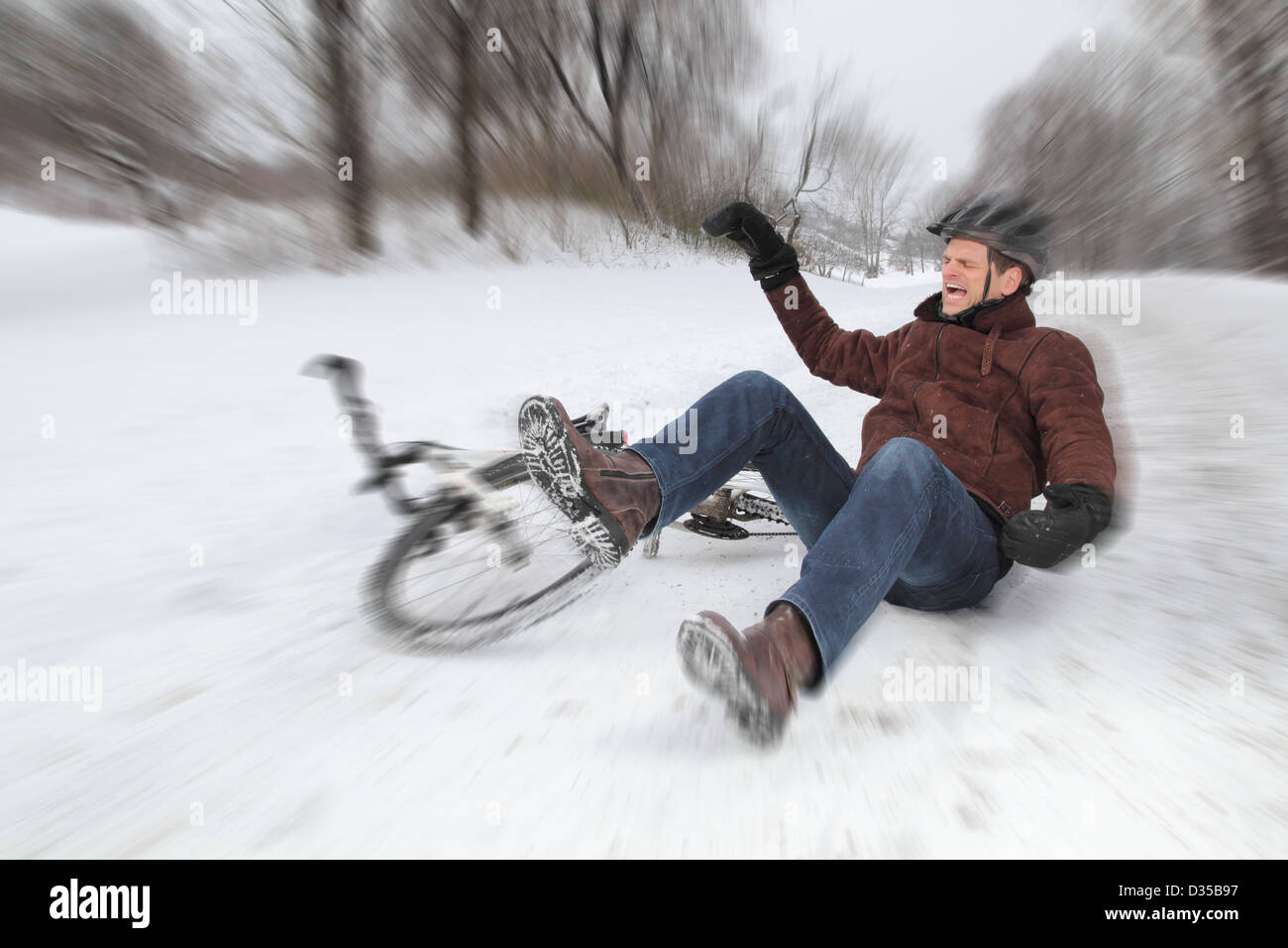 Bicycle accident on a snowy street with a falling man Stock Photo