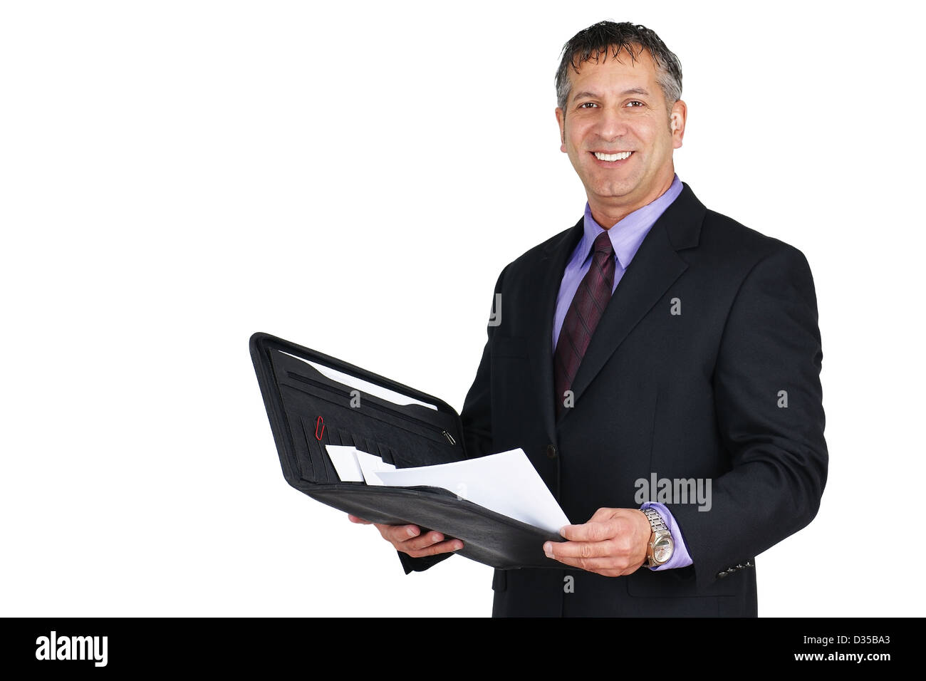 Man in suit and tie, holding paperwork and smiling, can be boss or management employee. Stock Photo