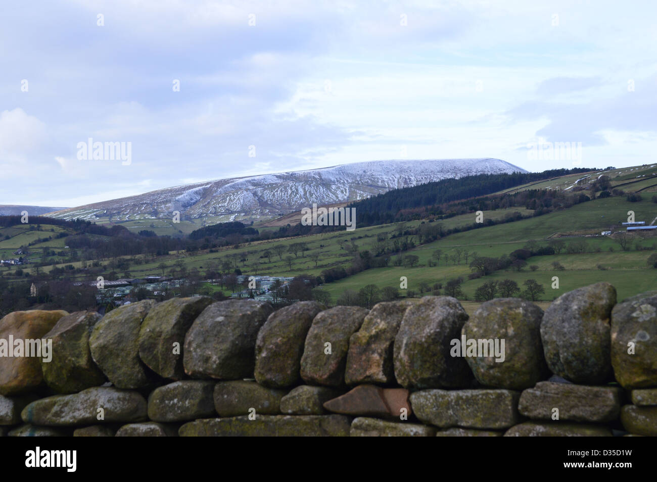Pendle Hill from the top of Pasture Lane Between Barrowford and Roughlee in winter with a Dry Stone Wall in the foreground. Stock Photo