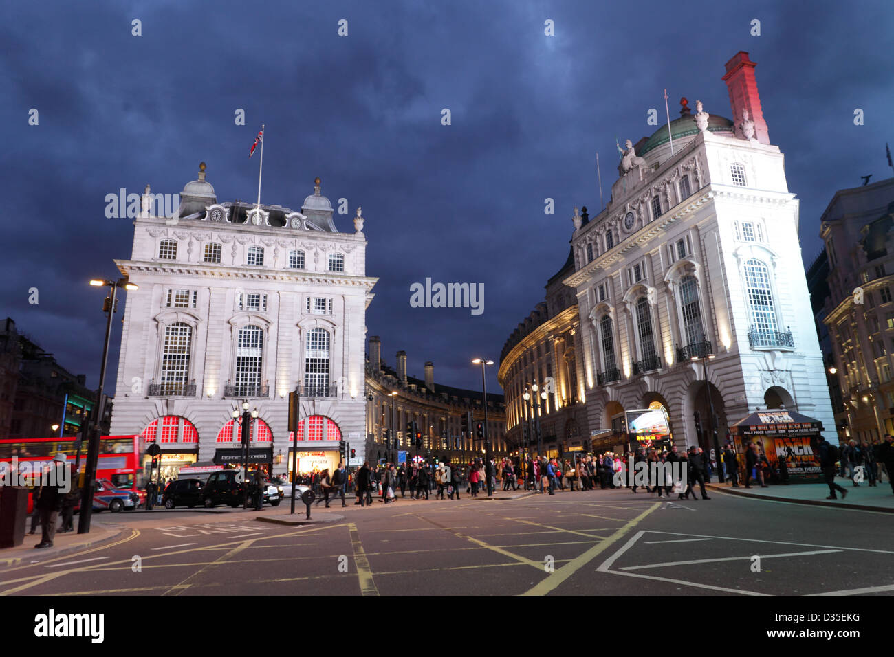 Piccadilly Circus, London, pictured in the early evening twylight and buildings lit up by giant adverts. Stock Photo