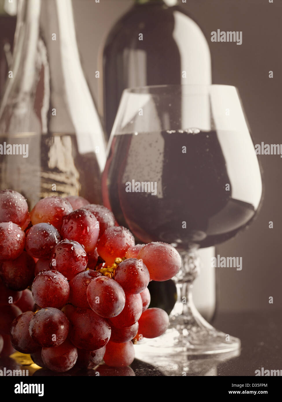 Old wine. Still life with wine bottles and goblet Stock Photo - Alamy