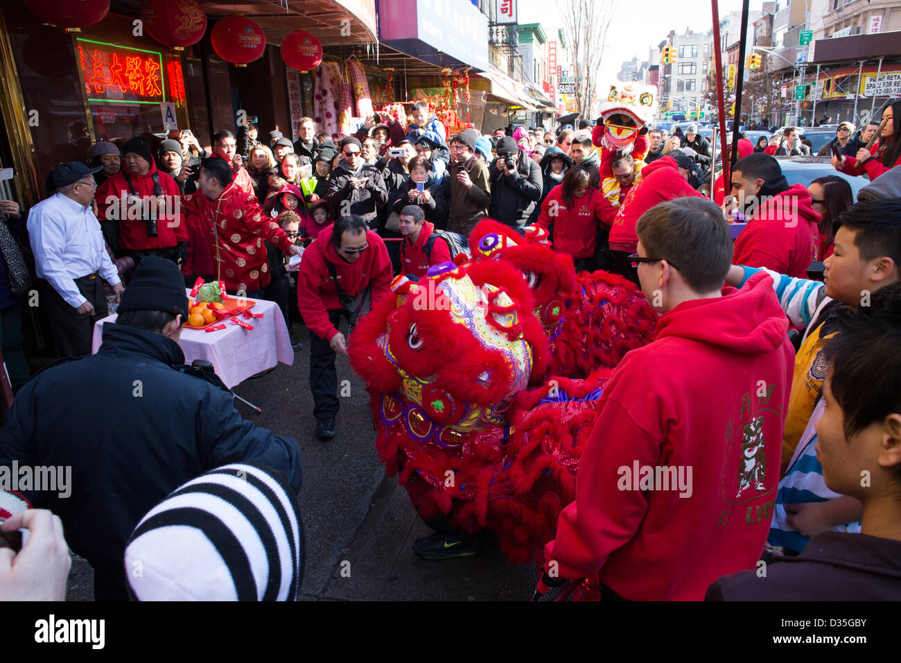 New York City, US, 10 February 2013. The Lucky King Bakery on Grand Street has fruit and vegetable offerings on the table for the lion. The lion is believed to bring good luck to the business in the coming year. Stock Photo