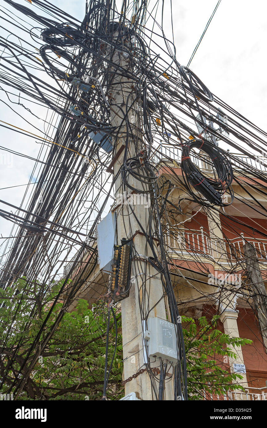 Rat's nest of electrical wiring typical of third world Asian countries. This is along one of Phnom Penh's streets. Cambodia. Stock Photo