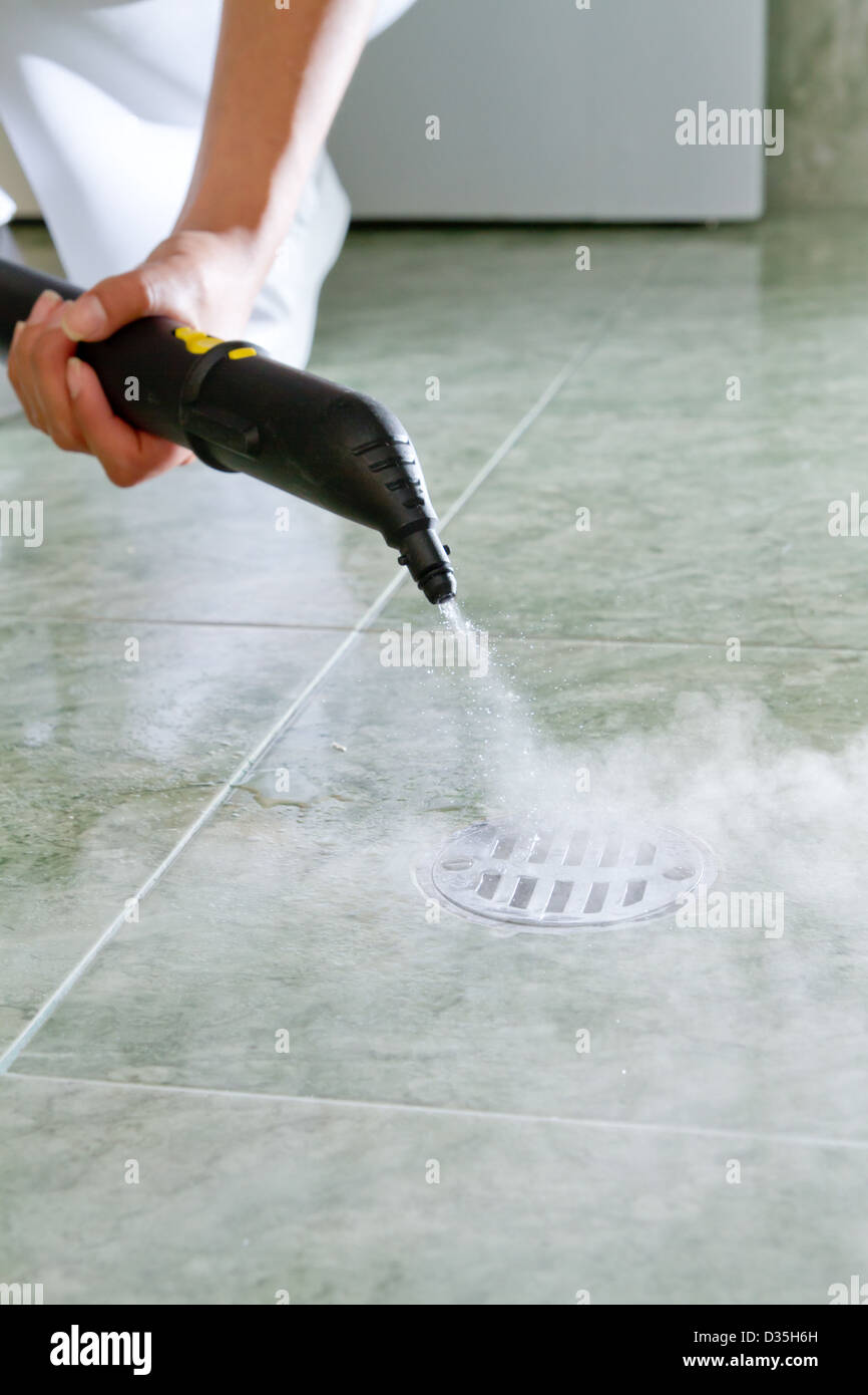 Woman cleaning drain in bathroom with steam Stock Photo Alamy