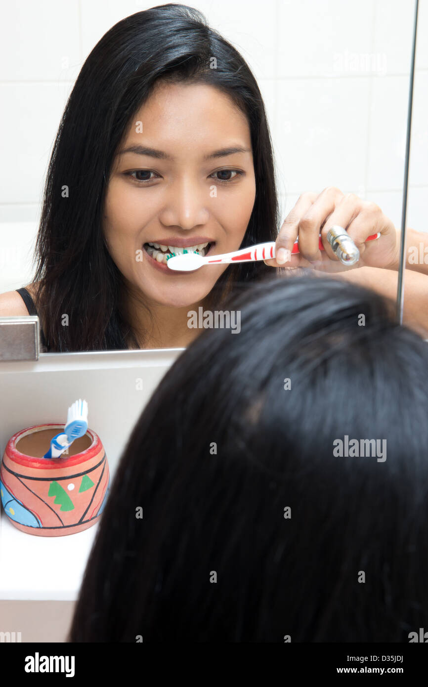 woman clean teeth toothbrush in bathroom Stock Photo Alamy