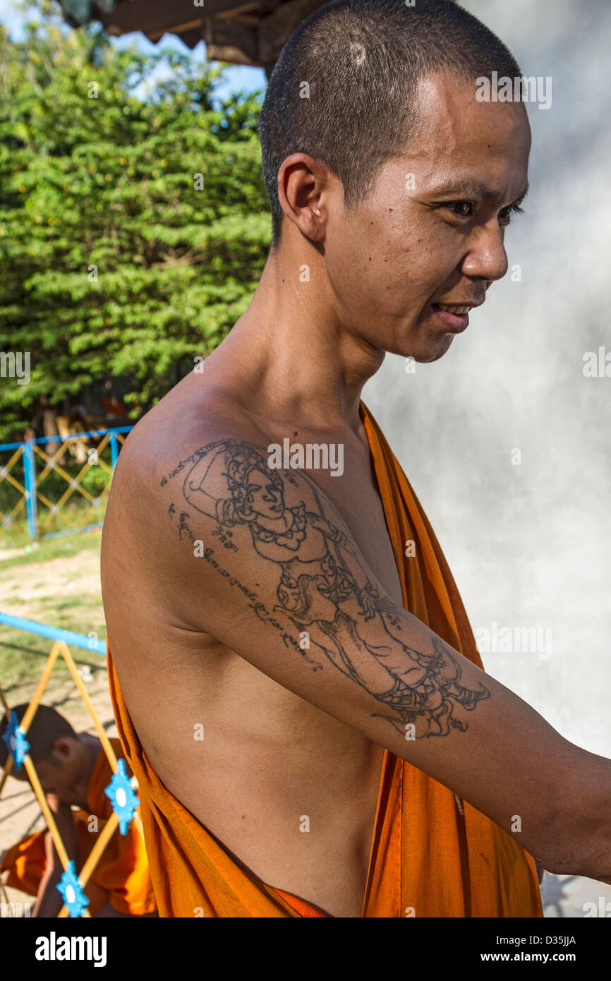 Buddhist monk with tattoo of 'mother earth' diety on his arm, Cambodia  Stock Photo - Alamy