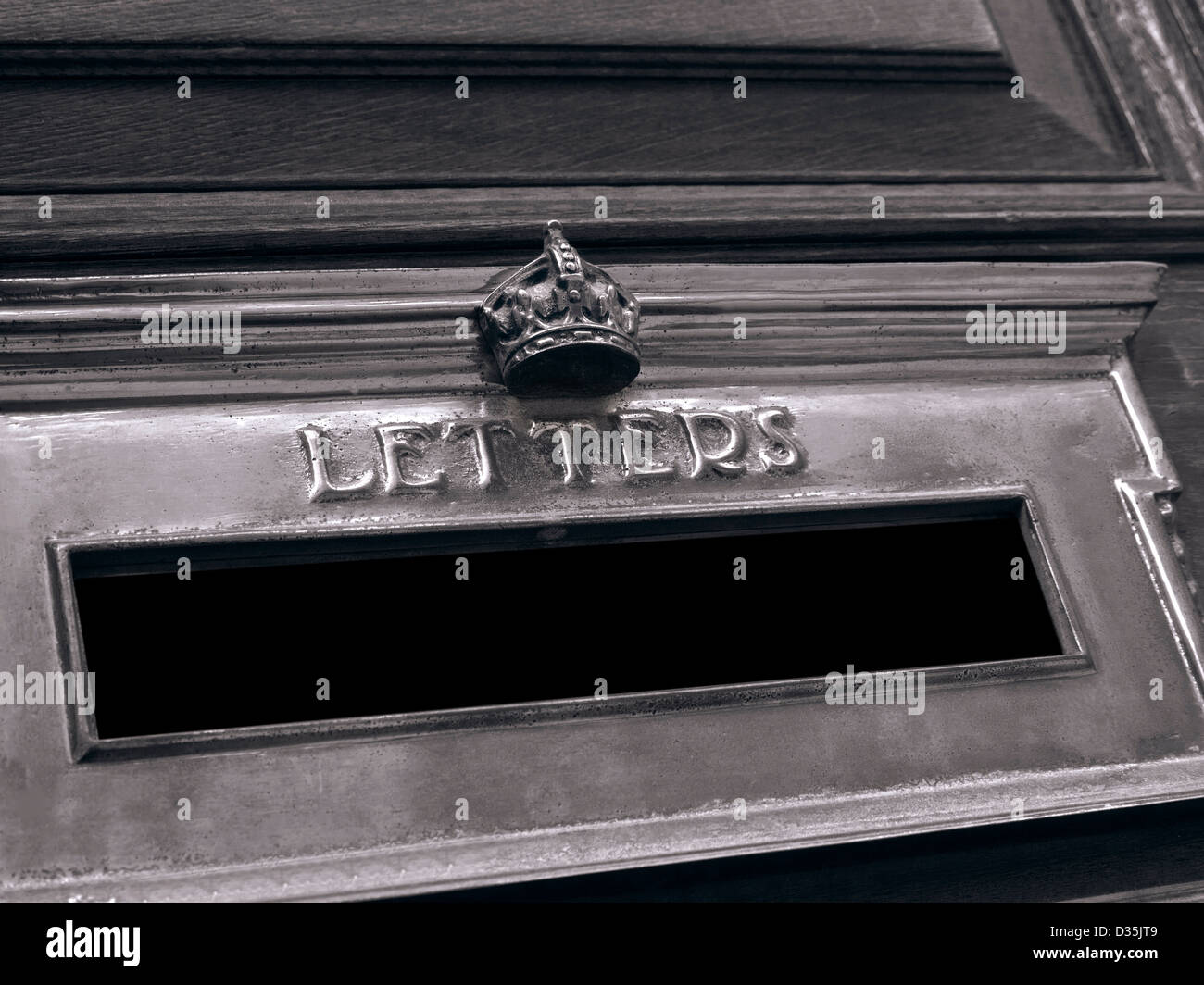 Concept B&W OHMS Crown crested official brass letter box on Government building door in central London UK Stock Photo