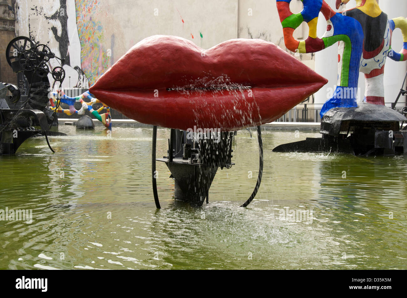 This huge pair of red lips called L’Amour by artists Jean Tinguely and Niki de Saint Phalle, is part of the Stravinsky fountain in Paris, France. Stock Photo