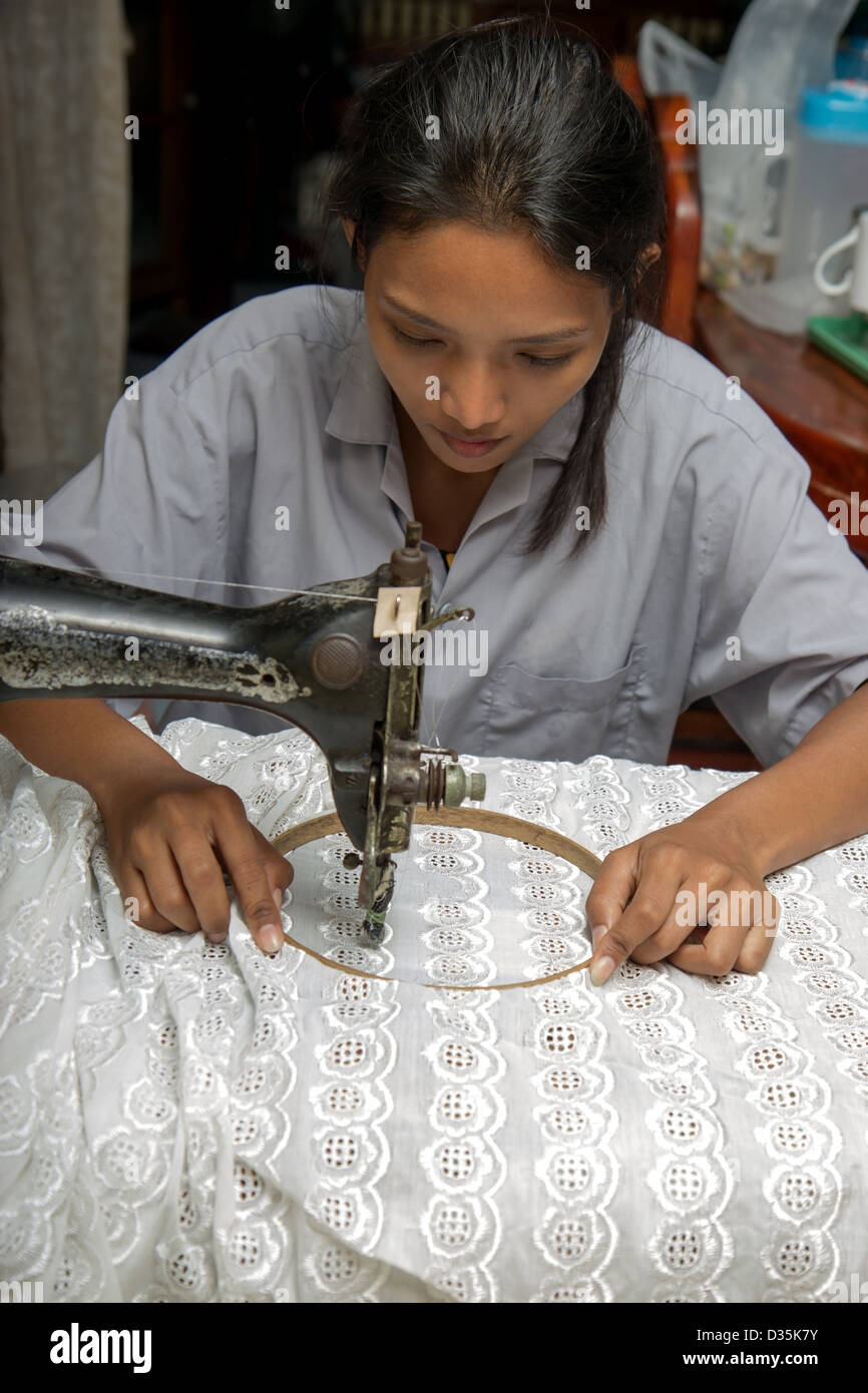 Asian woman using a sewing machine Stock Photo Alamy
