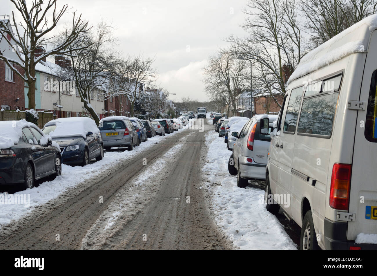 UK street lined with parked cars in the snow Stock Photo - Alamy