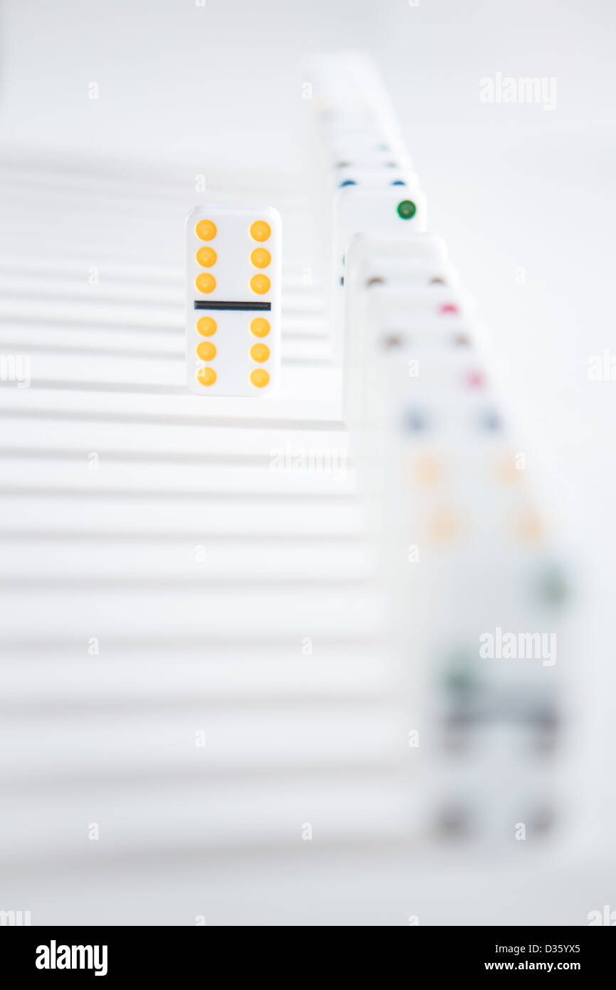 One domino standing separate to line Stock Photo