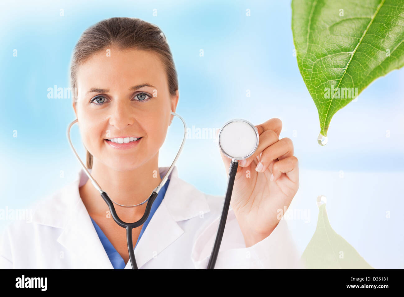 Doctor holding up stethoscope for natural treatment Stock Photo