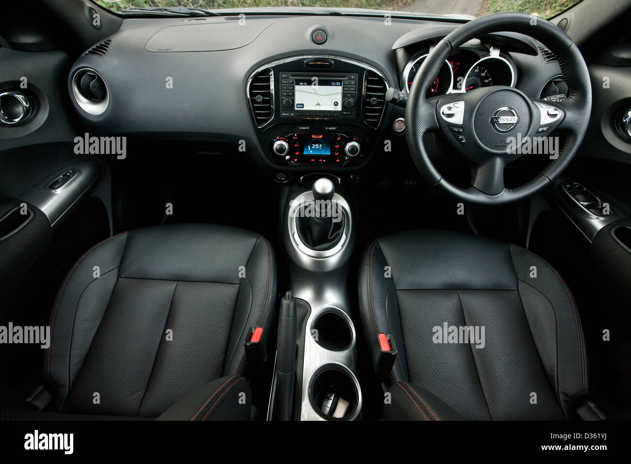 Driver and passenger seats with steering wheel in Nissan Juke Mini SUV, Southampton, UK, 1 11 2010 Stock Photo