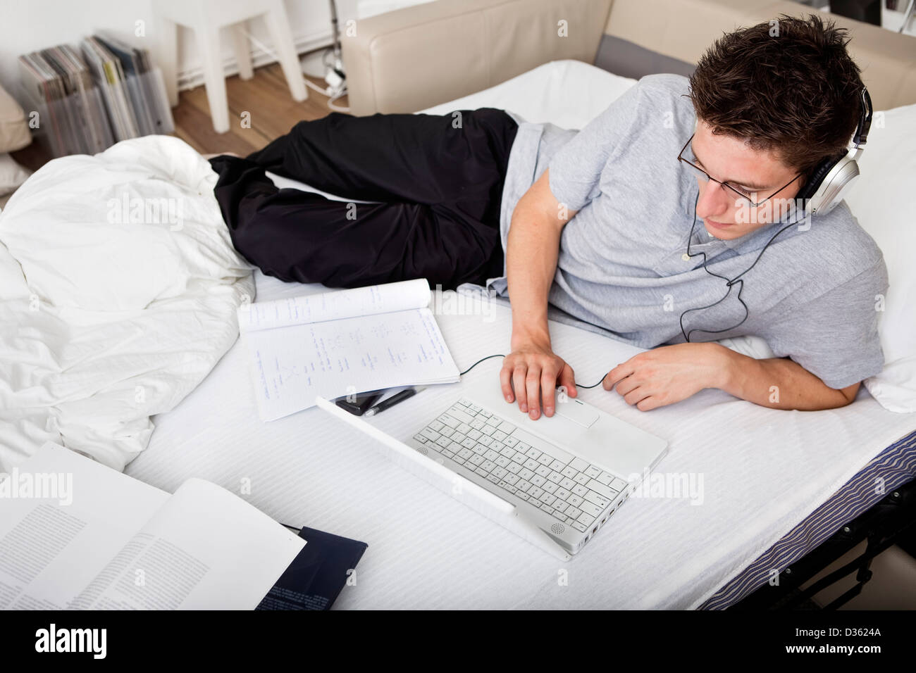 Young male student studying at home Stock Photo - Alamy