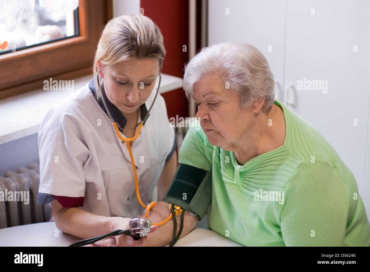 nurse makes home visits and measured blood pressure Stock Photo