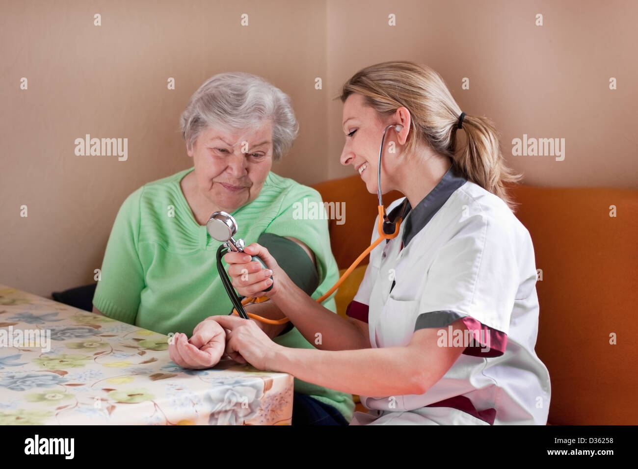 nurse measures the blood pressure of a patient Stock Photo
