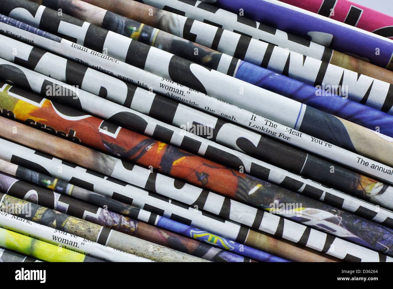 close up on a pile of different color newspaper titles Stock Photo