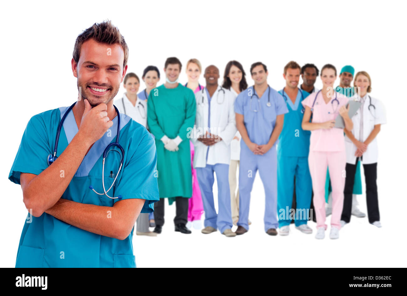 Happy surgeon with medical staff behind him Stock Photo