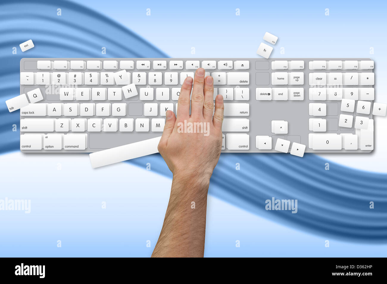 Hand breaking white and grey keyboard Stock Photo