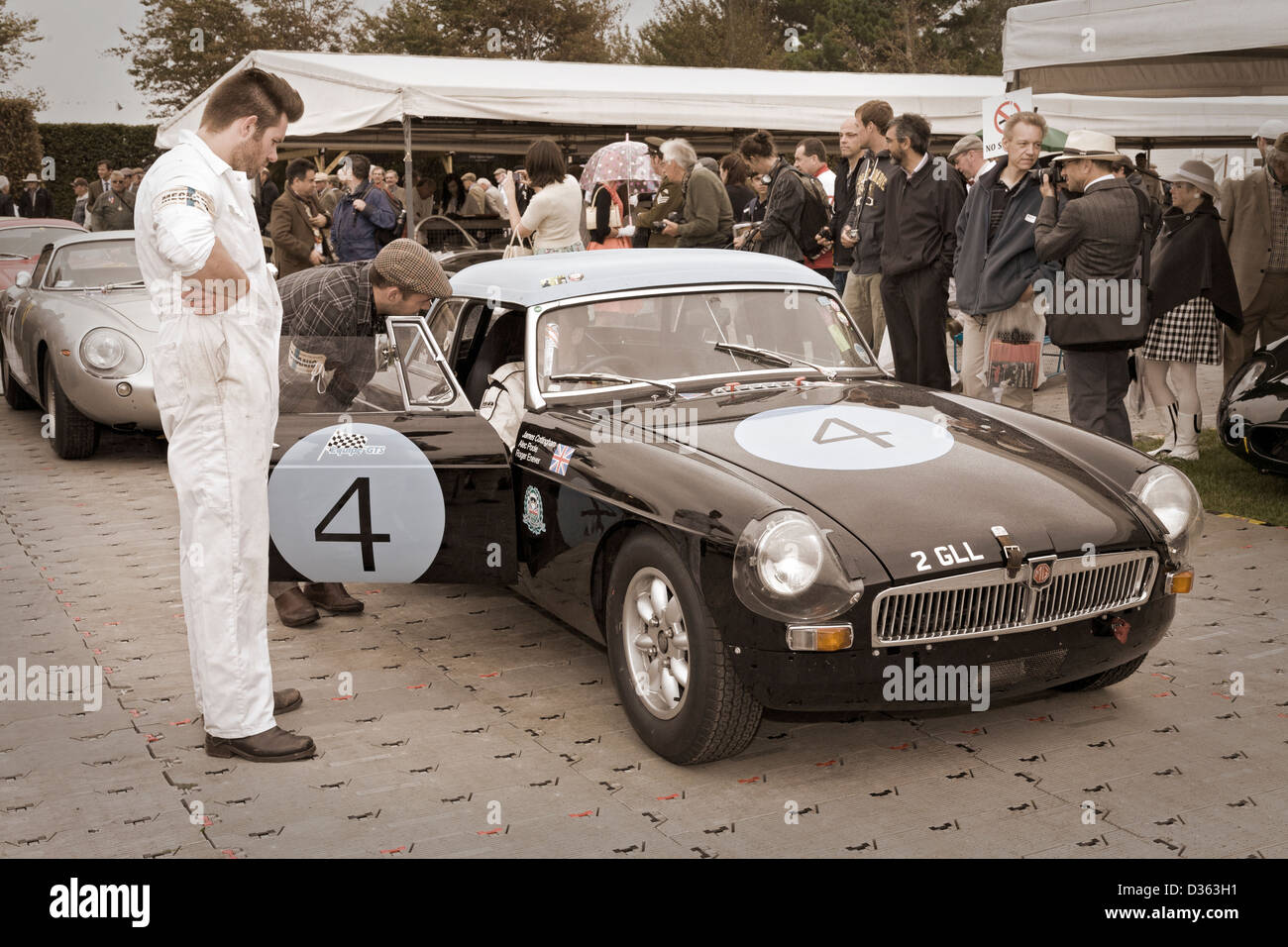 James Cottingham waits in the paddock in the1963 MGB at the 2012 Goodwood Revival, Sussex, UK. Stock Photo