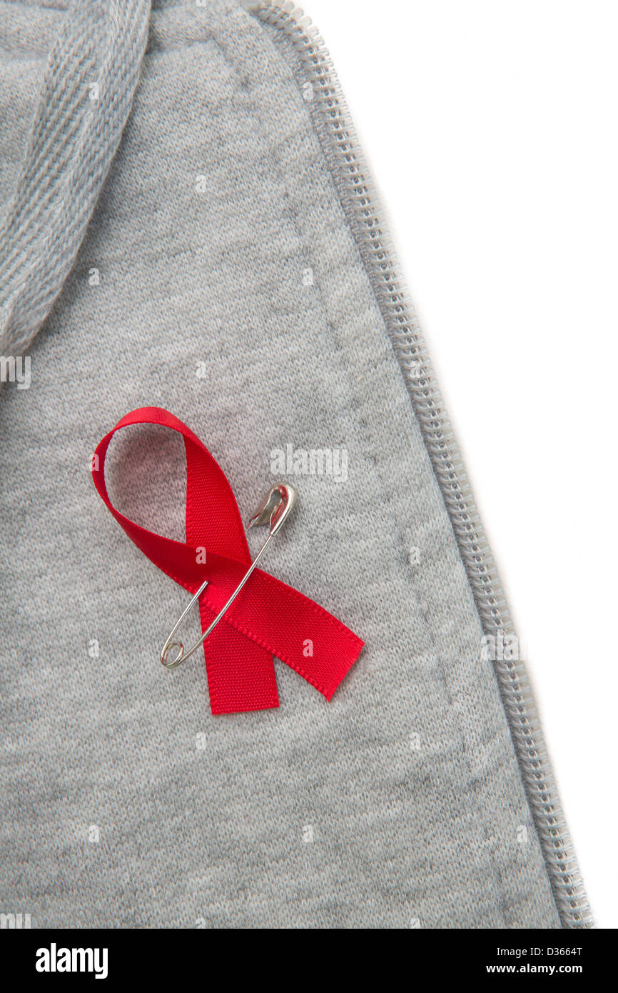 Aids awareness ribbon pinned on to grey hoodie Stock Photo