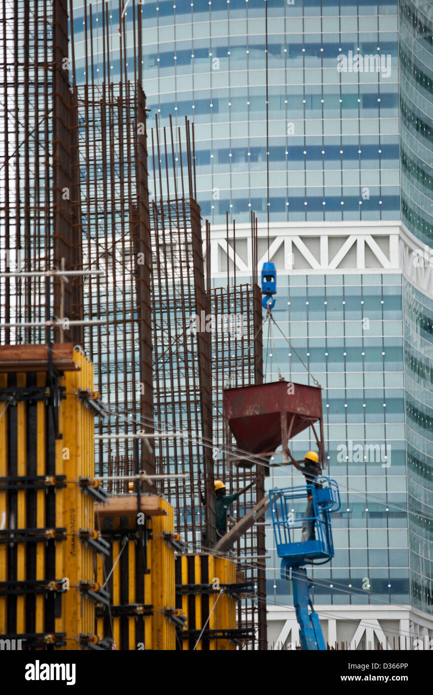 Workers at work on the construction site of the One-North complex in Singapore, 2008 Stock Photo