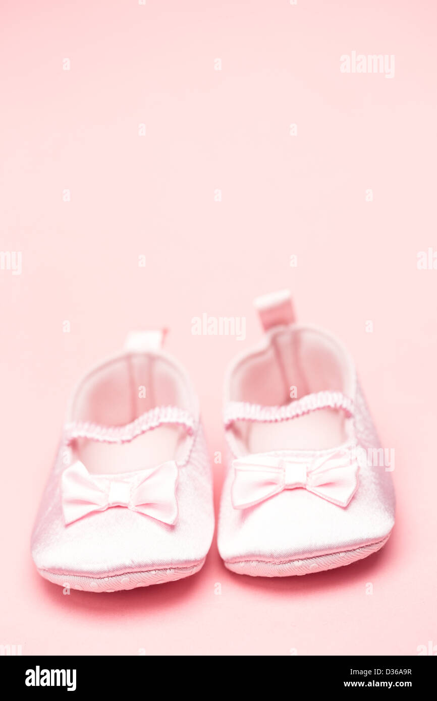 Baby girls pink booties with copy space Stock Photo Alamy