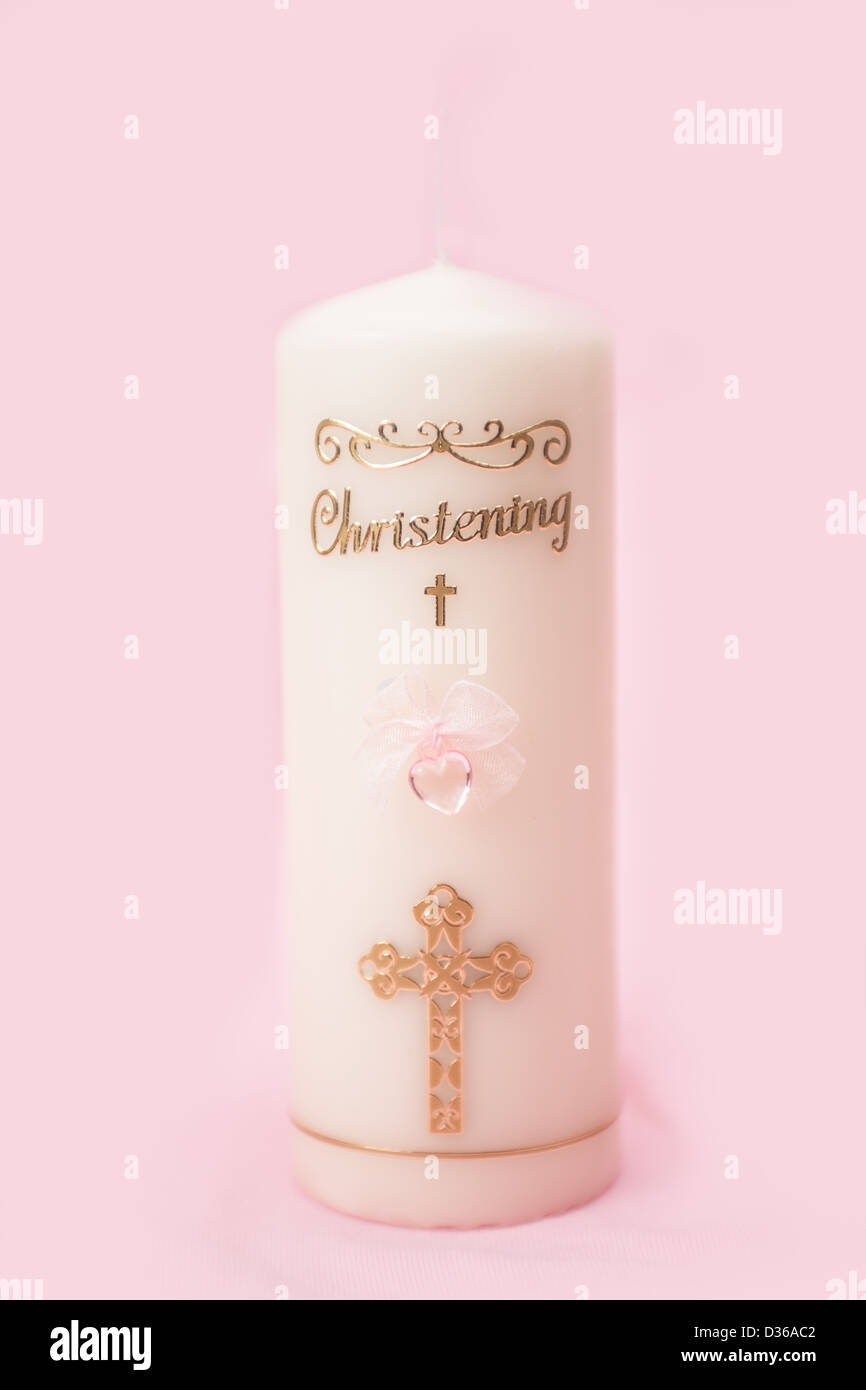 Christening candle with pink detail Stock Photo - Alamy