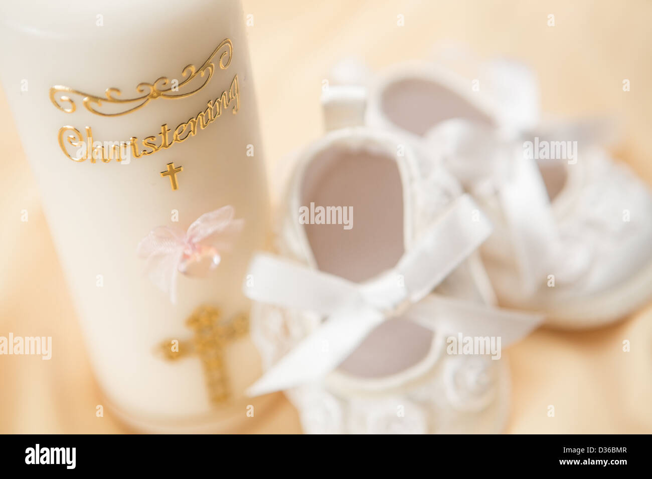 Baptism candle and baby booties Stock Photo Alamy