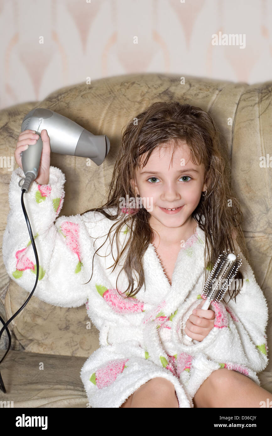 The little girl dries hair after bathing Stock Photo Alamy