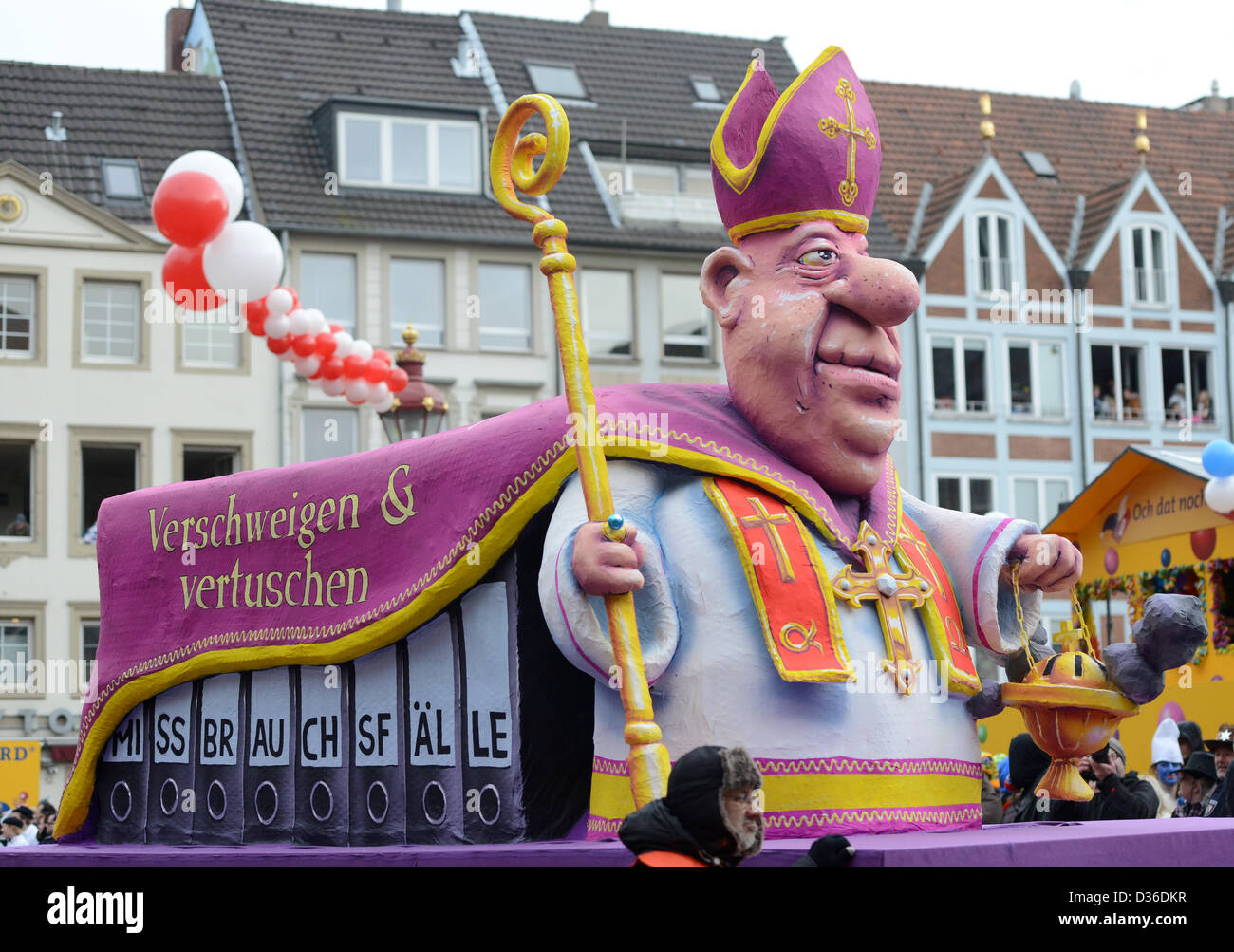 A carnival float on the topic of abuse in the church takes part in the
