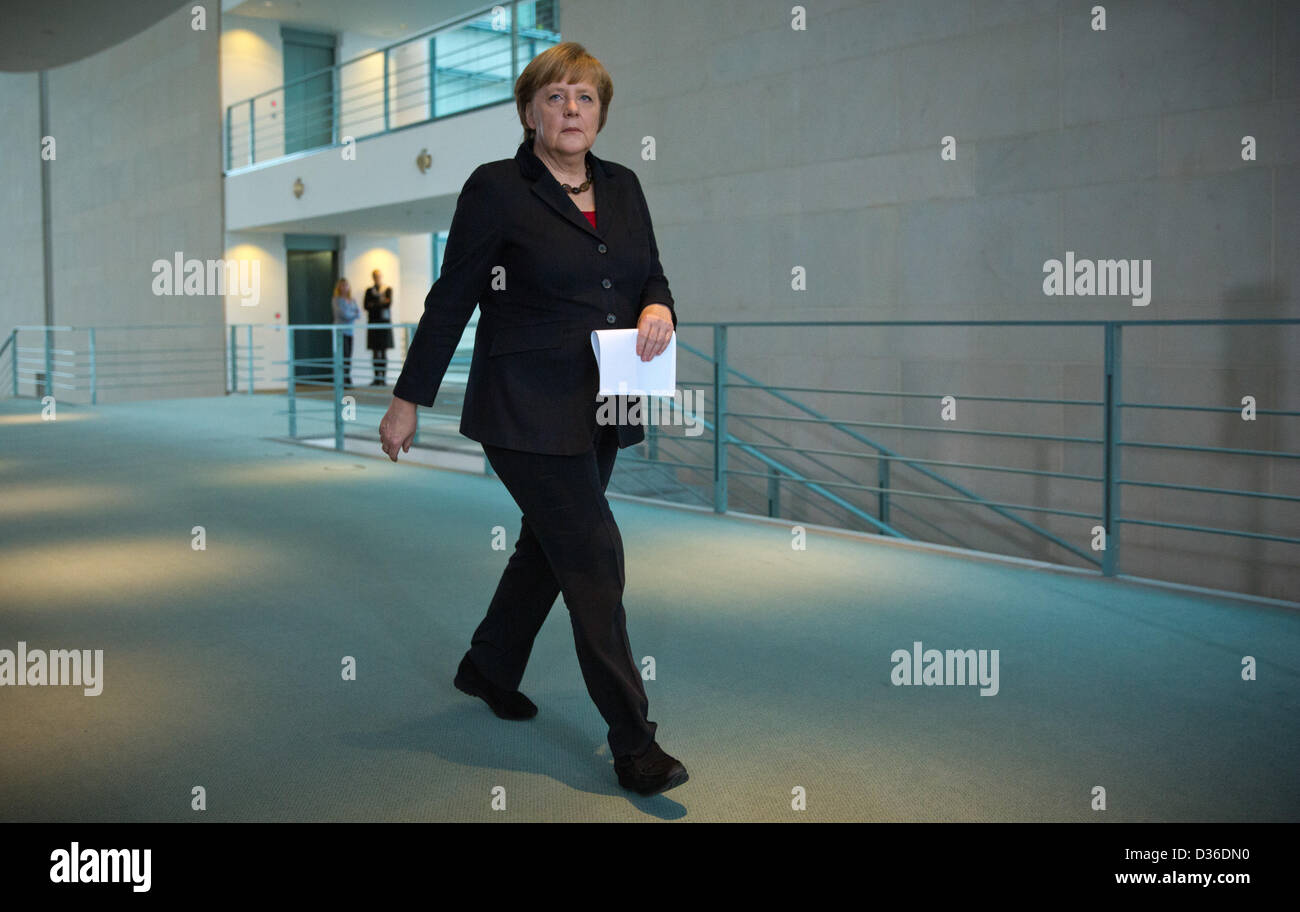 German Chancellor Angela Merkel walks to a press conference about the