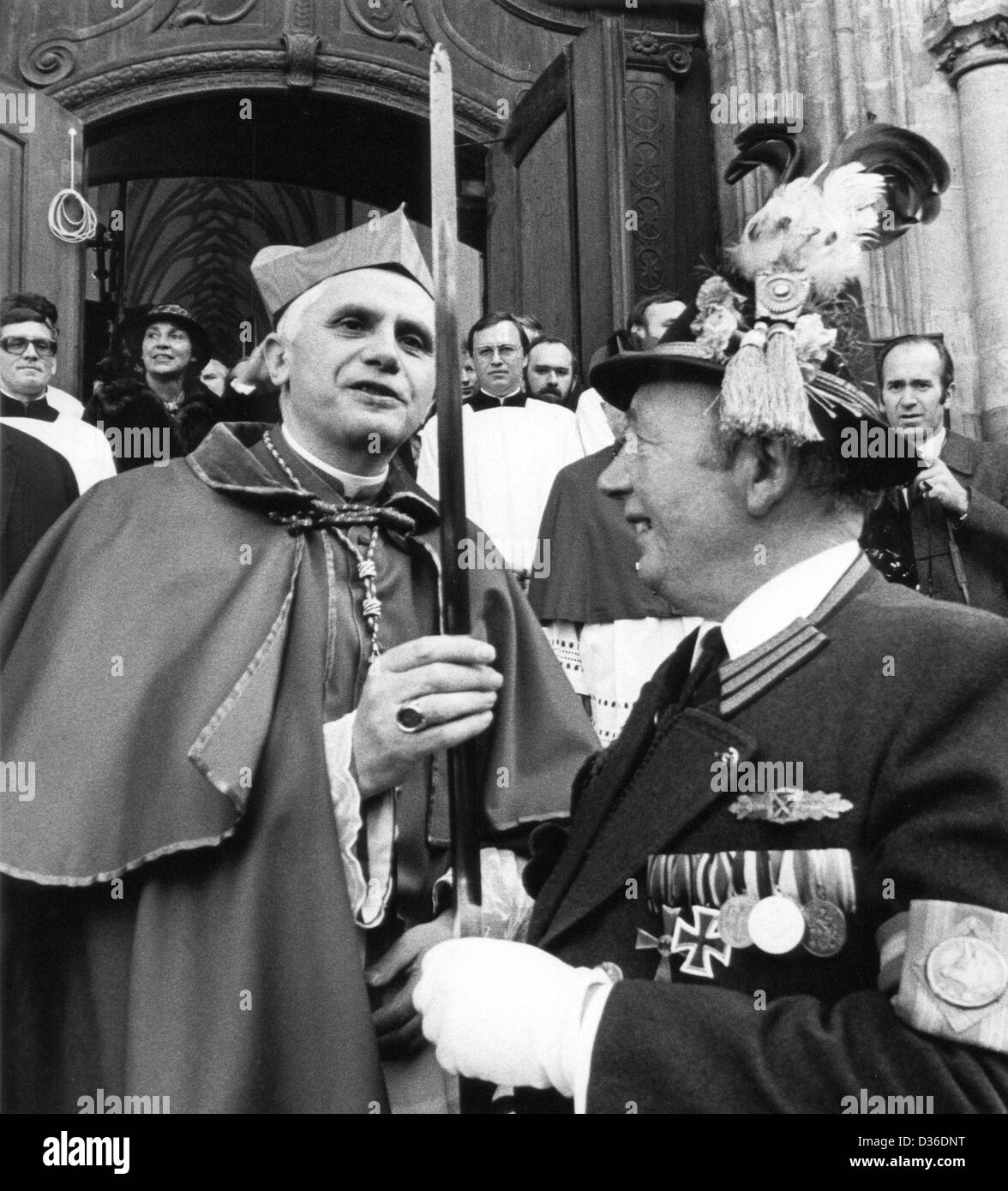 (FILE) An archive photo dated 28 February 1982 shows then Cardnial Joseph Ratzinger (L) examining the sharpness of the sword of Andreas Stadler, Captain of the traditional Bavarian mountain troops, in Munich, Germany, 28 February 2013. Ratzinger, former archbishop of Munich and Freising, was elected as pope on 19 April 2005. Photo: dpa Stock Photo