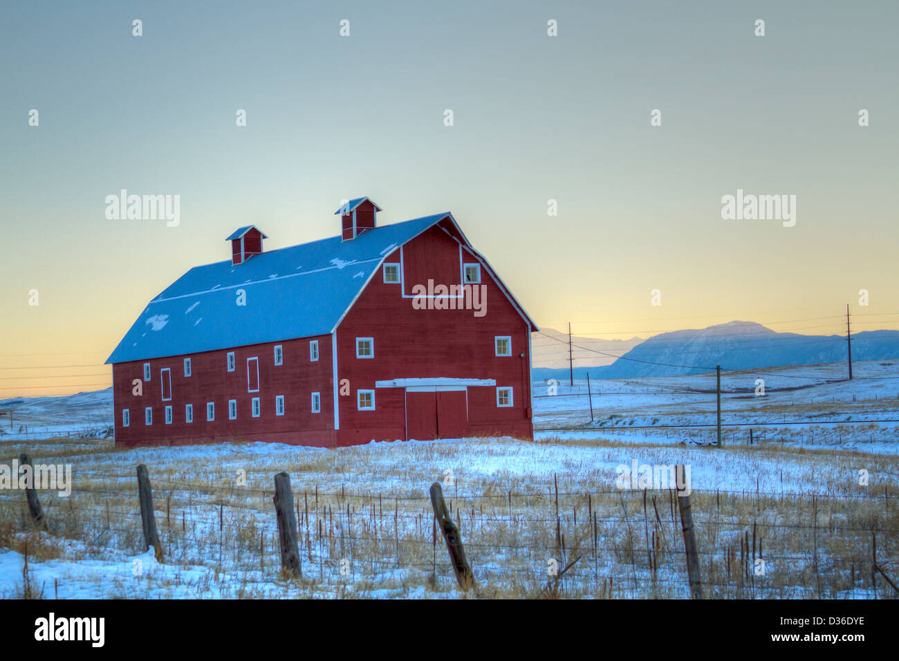 Red barn on the field covered in snow Stock Photo - Alamy