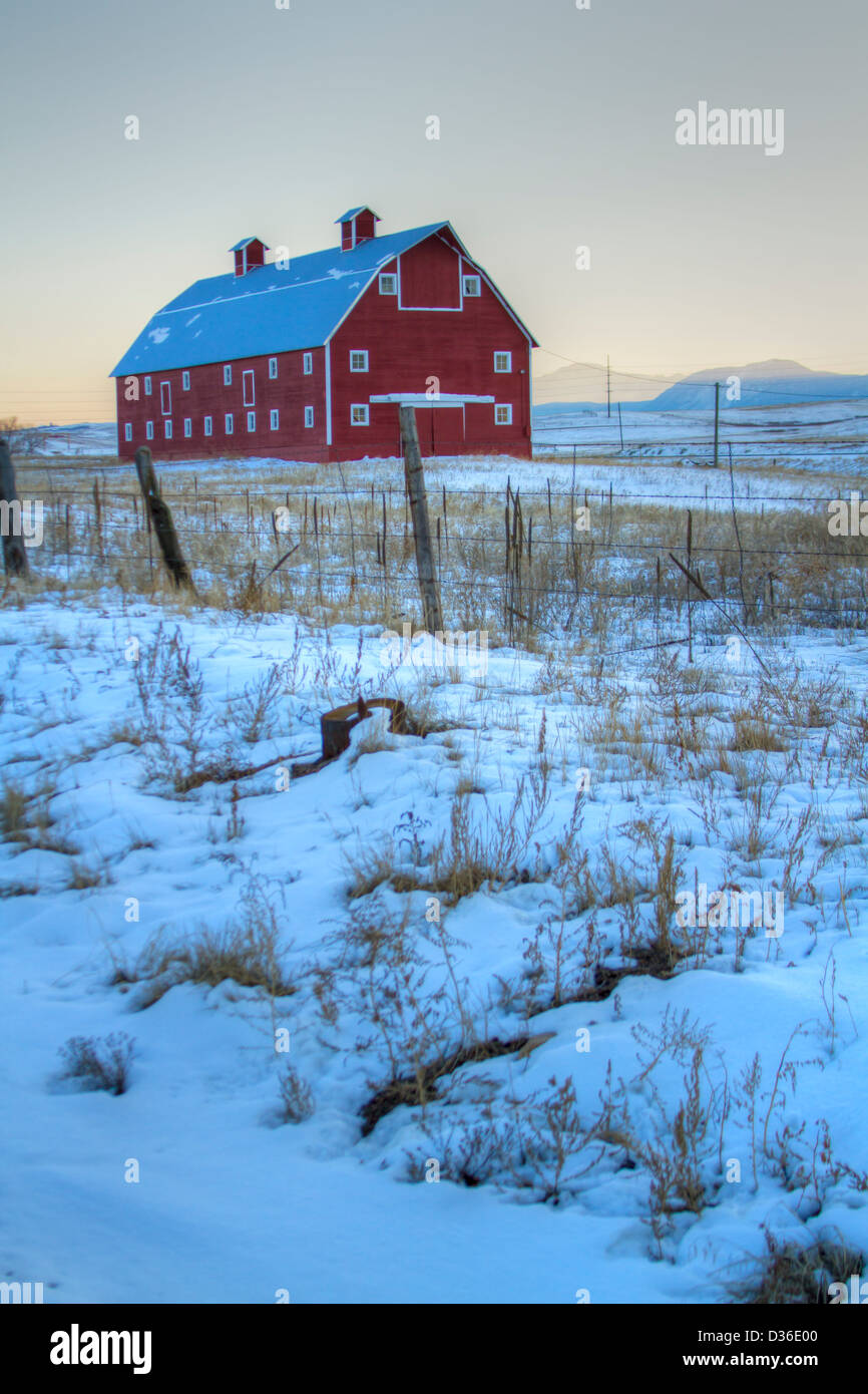 Red barn on the field covered in snow Stock Photo - Alamy