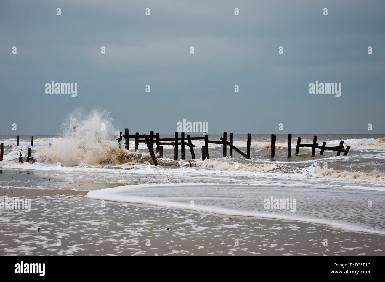 Old Sea defences with Waves breaking Happisburgh Beach coastal erosion ...