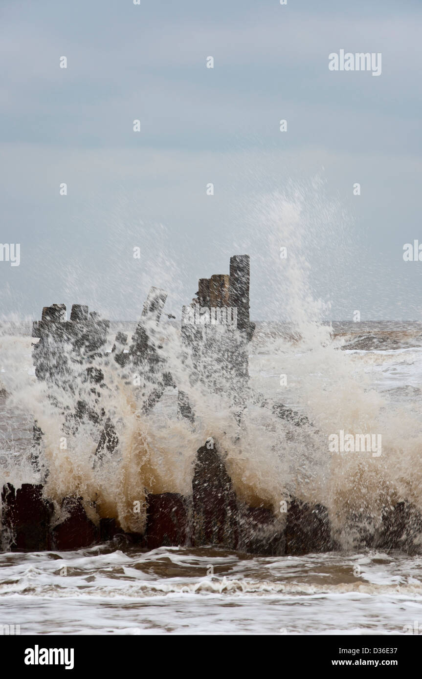 Old Sea defences with Waves breaking Happisburgh Beach coastal erosion ...