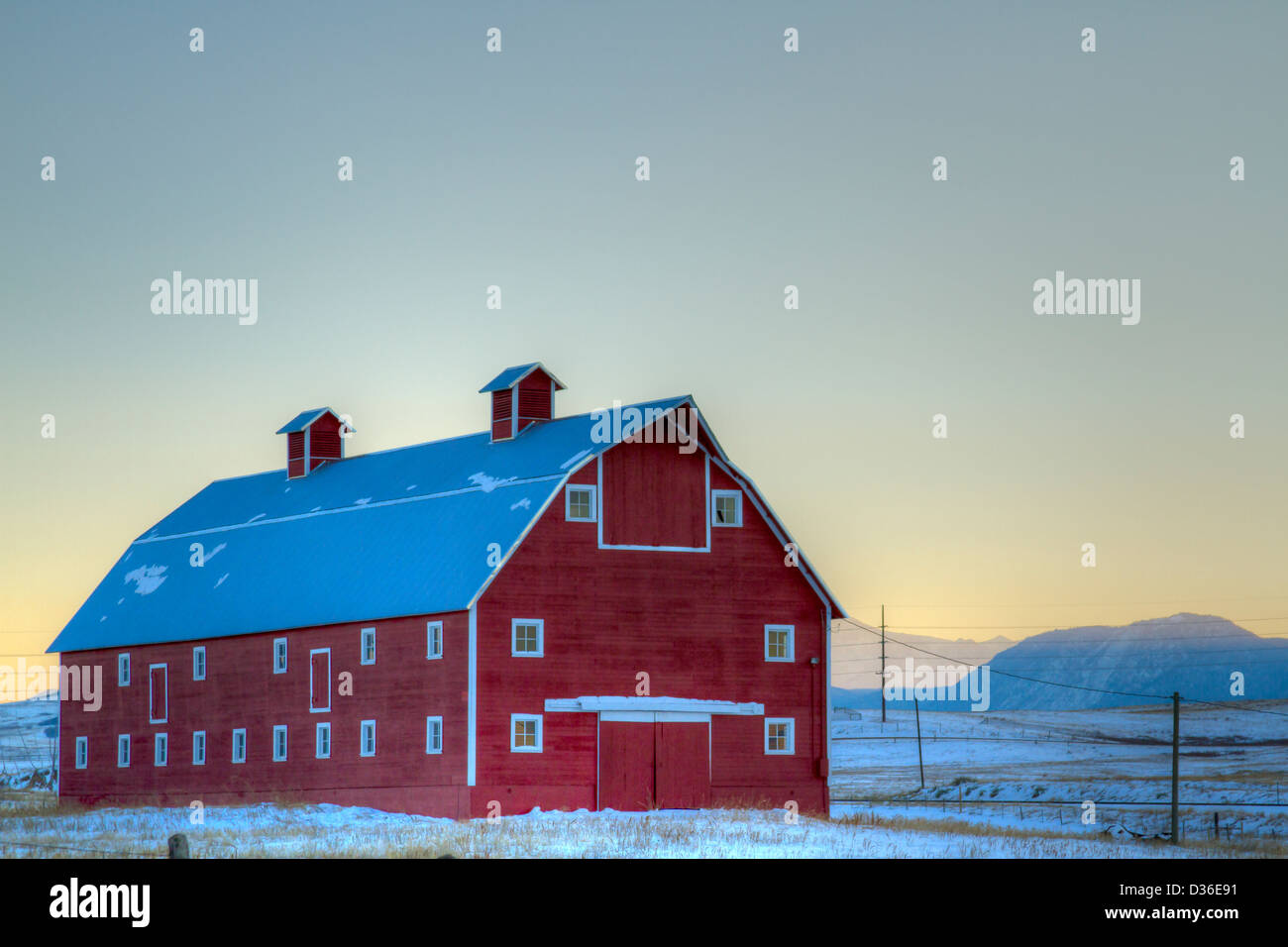 Red barn on the field covered in snow Stock Photo - Alamy