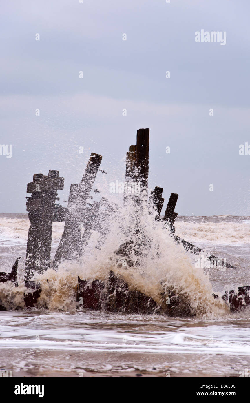 Old Sea defences with Waves breaking Happisburgh Beach coastal erosion ...