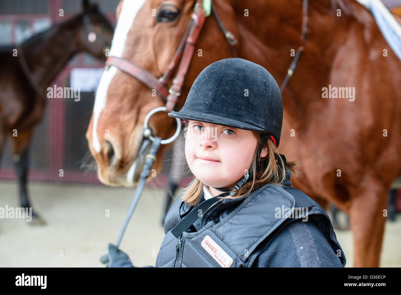 portrait of little girl with Down syndrome and his horse Stock Photo