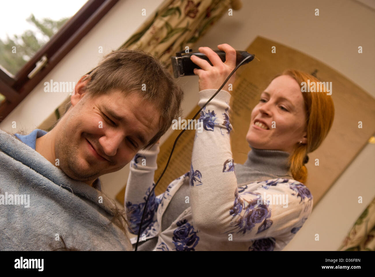 26 year old man in process of having all his hair shaved off for a cancer charity, Bordon, Hampshire, UK. Stock Photo