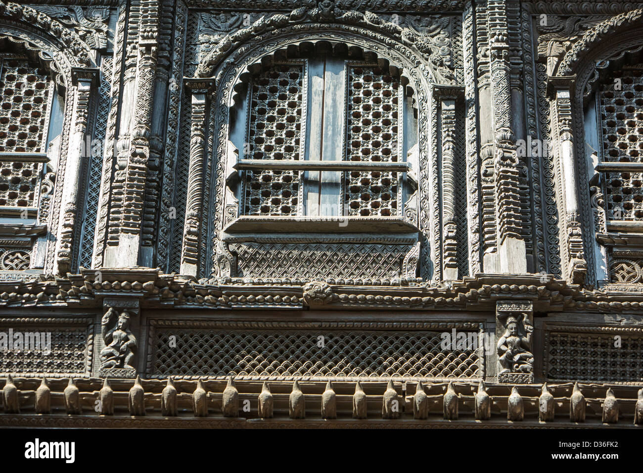 Ancient, ornately carved wood window frames on an old building in