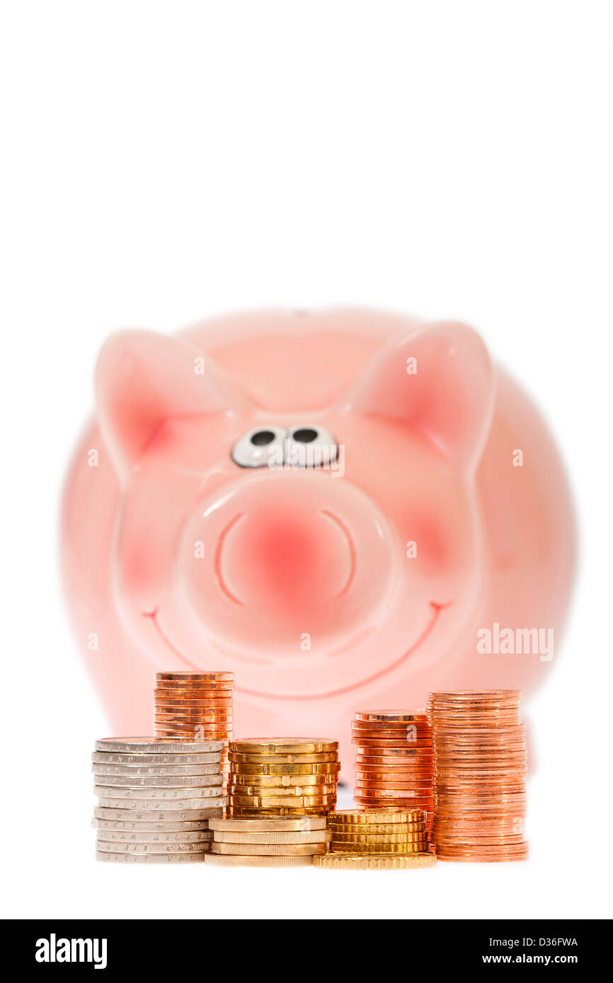 Pink piggy bank with stacks of euro coins against white background ...