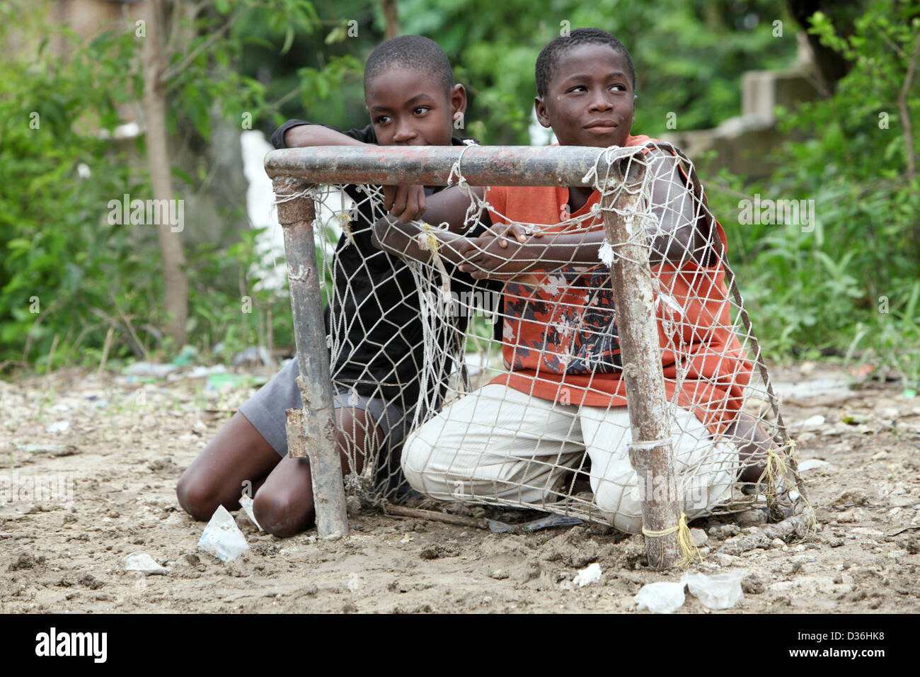 Leogane, Haiti, two children sitting behind a makeshift soccer goal Stock Photo