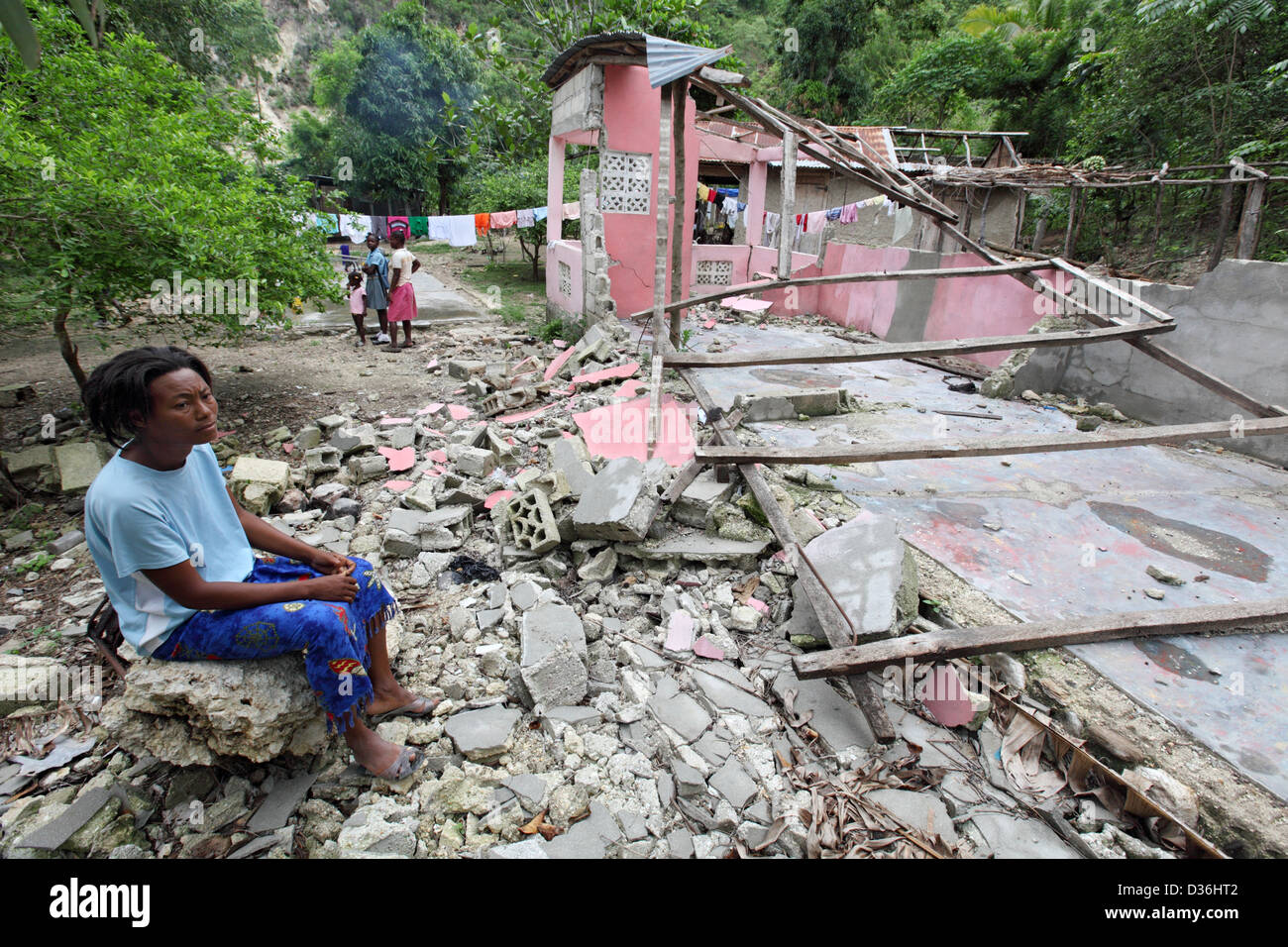 Leogane, Haiti, a woman sitting in front of her house was destroyed by